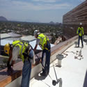 Installing shock track to all of the edges of the parapets walls using safety equipment and tie-offs.